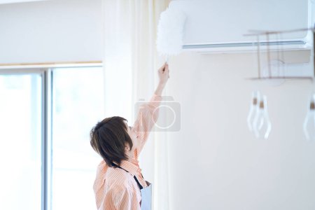 Photo for Asian woman cleaning the dust in the room - Royalty Free Image
