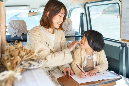 Téléchargez les photos : Mère et fille aiment dessiner dans un camping-car - en image libre de droit