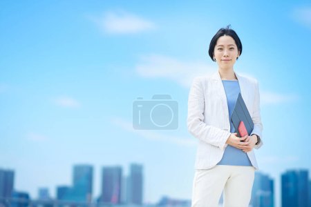 Photo for Business woman standing outdoors on fine day - Royalty Free Image