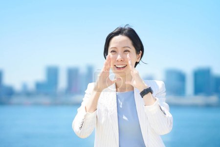 Photo for Business woman cheering with a smile on fine day - Royalty Free Image
