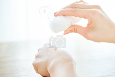 Photo for Hand of a woman who puts emulsion on her hand - Royalty Free Image