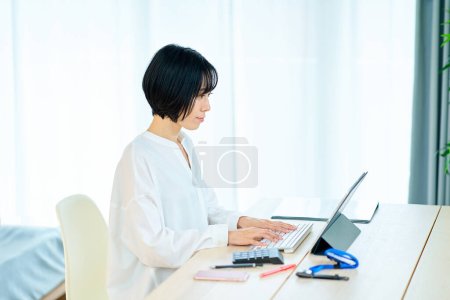 Photo for Asian woman using laptop in the room - Royalty Free Image