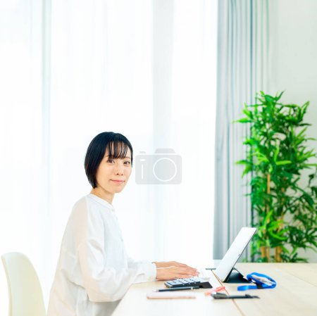Photo for Asian woman using laptop in the room - Royalty Free Image