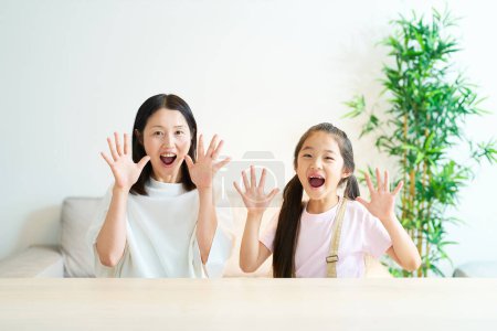 Photo for Parent and child making a surprised pose in the room - Royalty Free Image