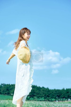 Foto de Una joven que muestra una expresión relajada bajo el cielo despejado - Imagen libre de derechos