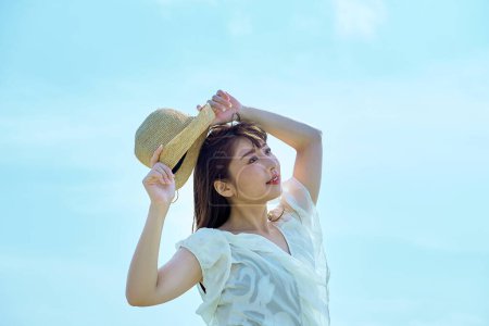 Photo for A young woman showing a relaxed expression under the clear sky - Royalty Free Image