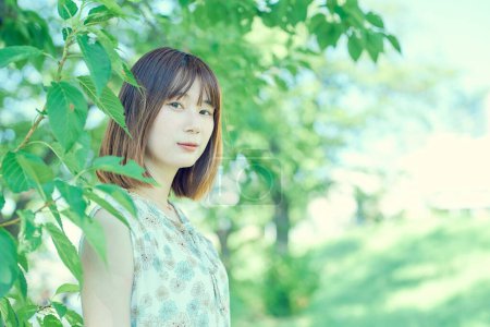 Photo for Woman portrait in green space on fine day - Royalty Free Image