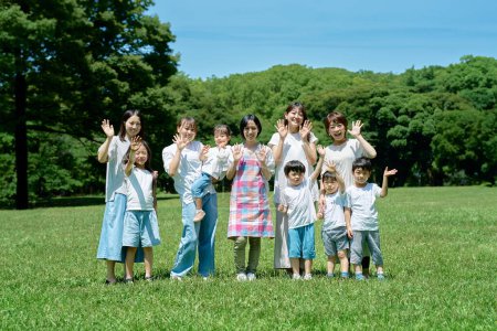 Photo for Group photo of children, parents and teacher outdoors - Royalty Free Image