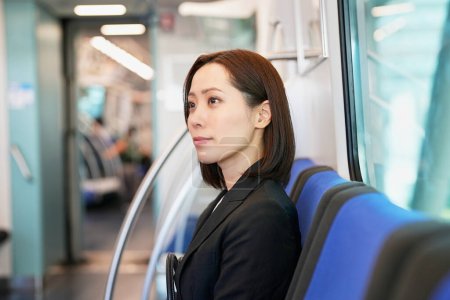 Photo for Business woman sitting on a train seat - Royalty Free Image