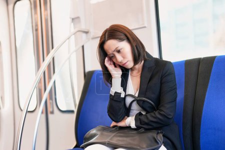 Photo for A business woman feels unwell on the train - Royalty Free Image