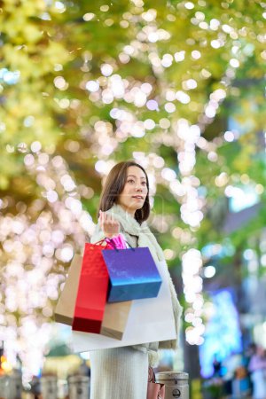 Photo for A woman carrying many shopping bags in the town - Royalty Free Image