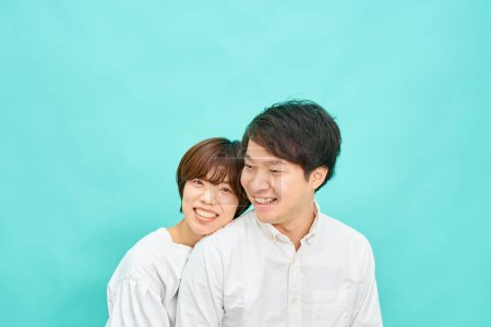 Photo for Man and woman in a friendly atmosphere in front of blue background - Royalty Free Image