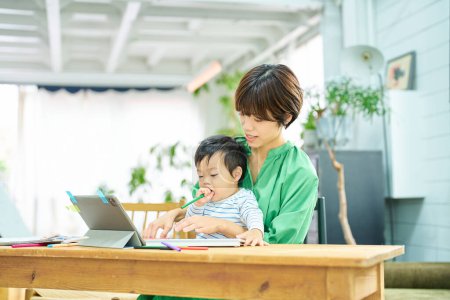 Photo for A woman working from home with a baby - Royalty Free Image