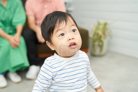 Photo for 1 year old child looking up indoors - Royalty Free Image