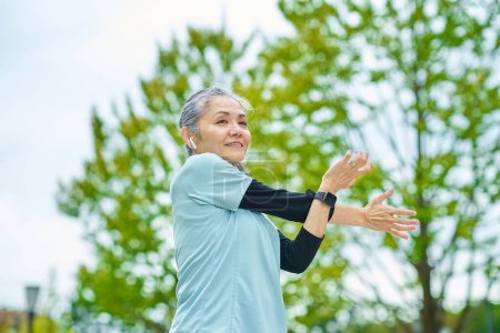 Photo for Smiling senior woman exercising outdoors - Royalty Free Image