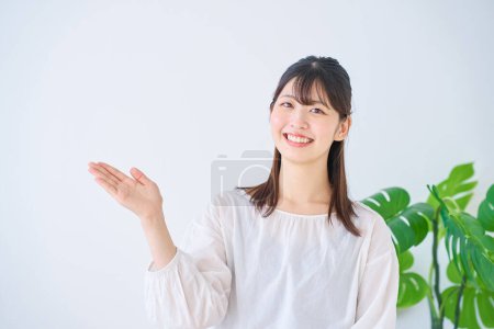 Photo for A young woman posing as a guide indoors - Royalty Free Image