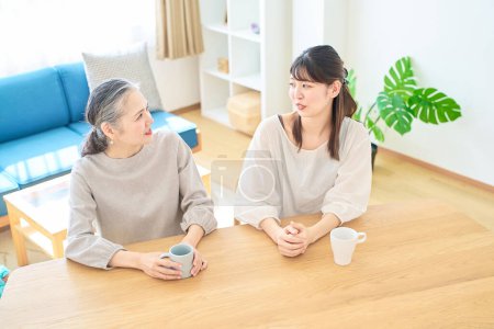 Photo for Senior woman and young woman talking friendly in the room - Royalty Free Image