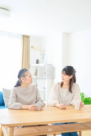 Photo for Senior woman and young woman talking friendly in the room - Royalty Free Image