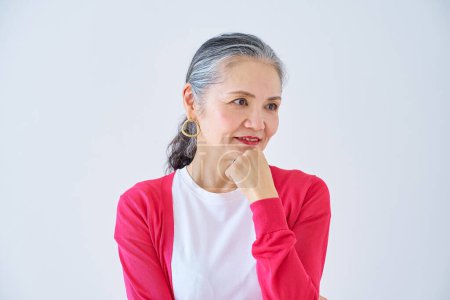 Photo for A senior woman with a doubtful expression indoors - Royalty Free Image