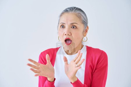 Photo for Senior woman with a surprised expression indoors - Royalty Free Image
