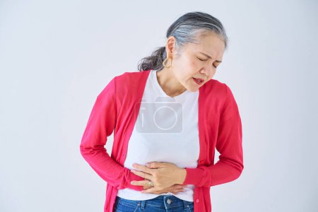 Photo for Senior woman suffering from abdominal pain indoors - Royalty Free Image