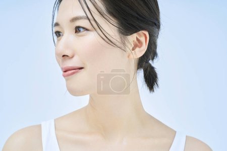 Beauty image of a woman standing in front of a plain background