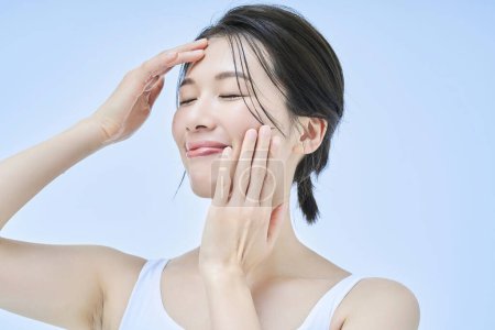 asian middle aged woman doing skin care