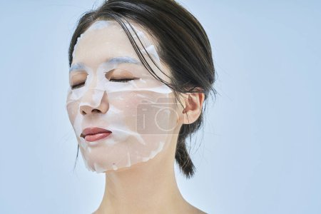 Photo for A woman doing skin care using a face pack - Royalty Free Image