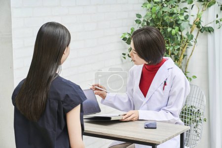 Photo for Female doctor talking with female patient - Royalty Free Image