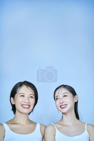 Photo for Two women lined up in sleeveless clothes - Royalty Free Image