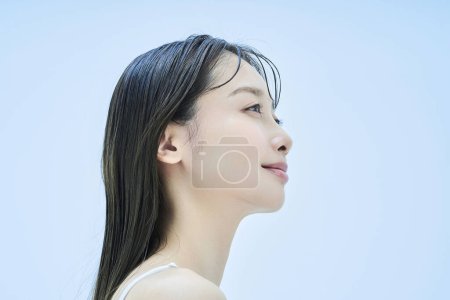 Photo for Asian young woman and light blue background - Royalty Free Image