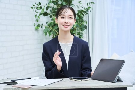 Photo for A woman in a suit talking with a smile at office - Royalty Free Image