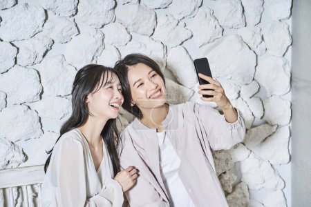 Photo for Two women looking at smartphone screen - Royalty Free Image