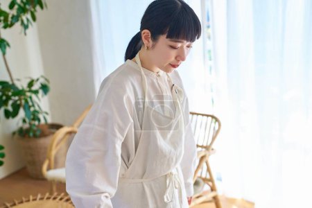 Photo for Young woman cleaning the flooring in the room - Royalty Free Image