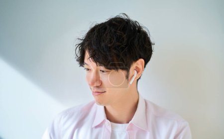 Young man wearing wireless earphones
