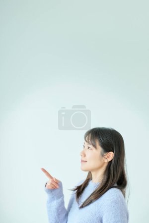 Young woman posing pointing indoors