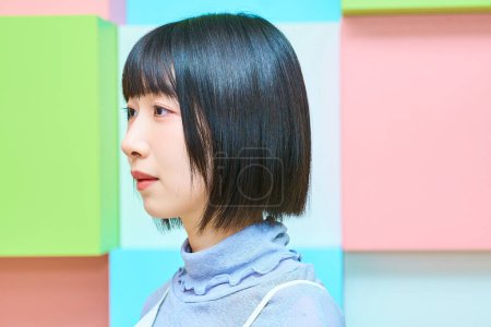 Colorful background with a young woman with a serious face