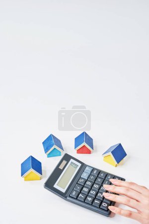 Colorful house models and calculator on the talbe