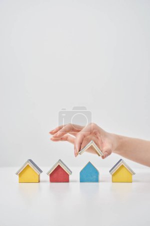 Models of multiple houses lined up on a white table