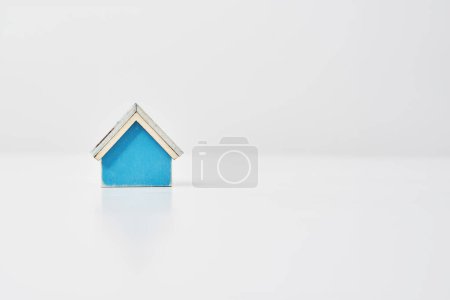 Photo for Blue house model placed on a white table - Royalty Free Image