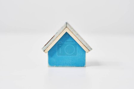 Blue house model placed on a white table