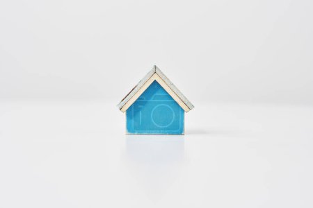 Blue house model placed on a white table