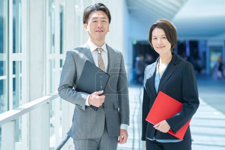 Middle-age man and woman in suits