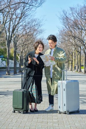 Middle-age man and woman who get lost with suitcases
