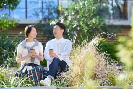 Man and woman talking intimately outdoors