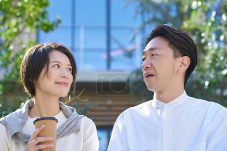 Man and woman talking intimately outdoors
