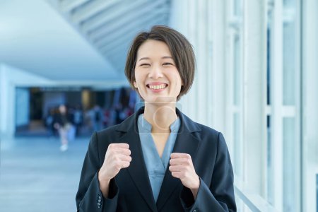Business woman smiling and doing a fist pump