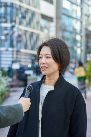 Middle-aged woman being interviewed on the street
