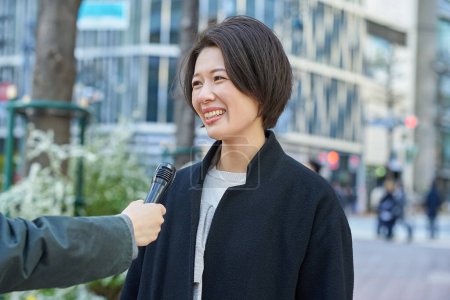 Middle-aged woman being interviewed on the street