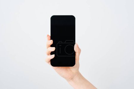 Hand of a woman holding a smartphone and white background